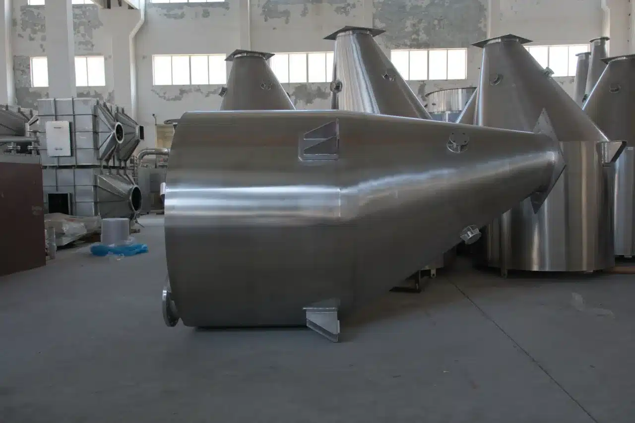 Multiple conical stainless steel spin flash dryers arranged in an industrial facility, highlighting their smooth finish and robust design.